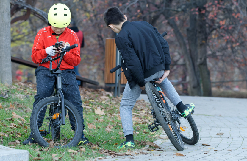 boys on bikes with mobile