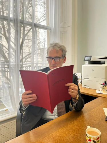 Image of Damian reading the spring budget document